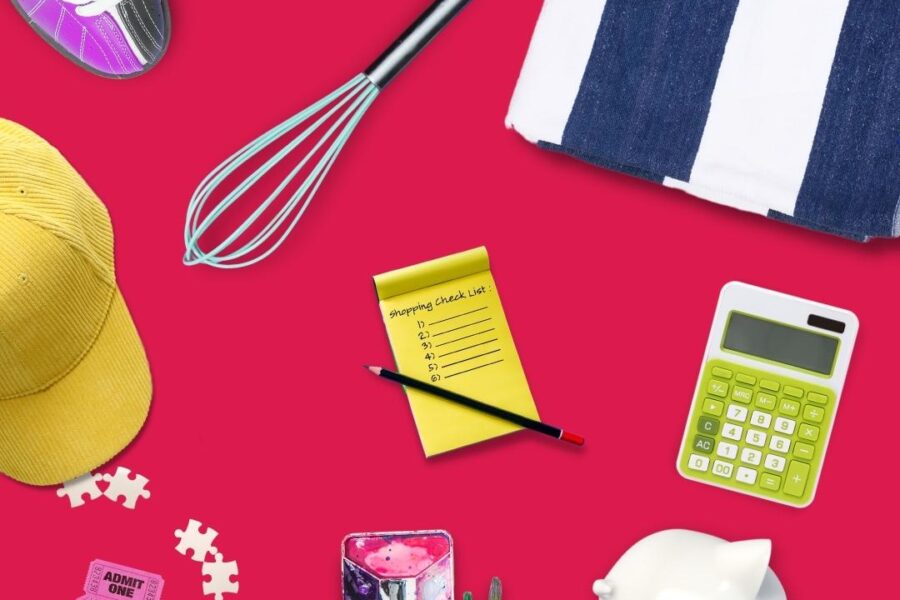 a table with items on it including a hat, puzzle pieces, paint and paintbrush, calculator, shopping list, whisk, bowling shoes and beach towel