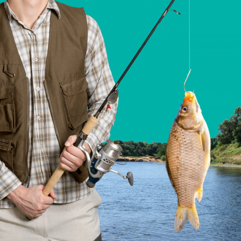 Man holding fishing rod with fish hanging on hook and a kake in the background